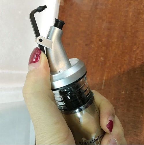 olive oil bottle sprayer spout in use lifestyle